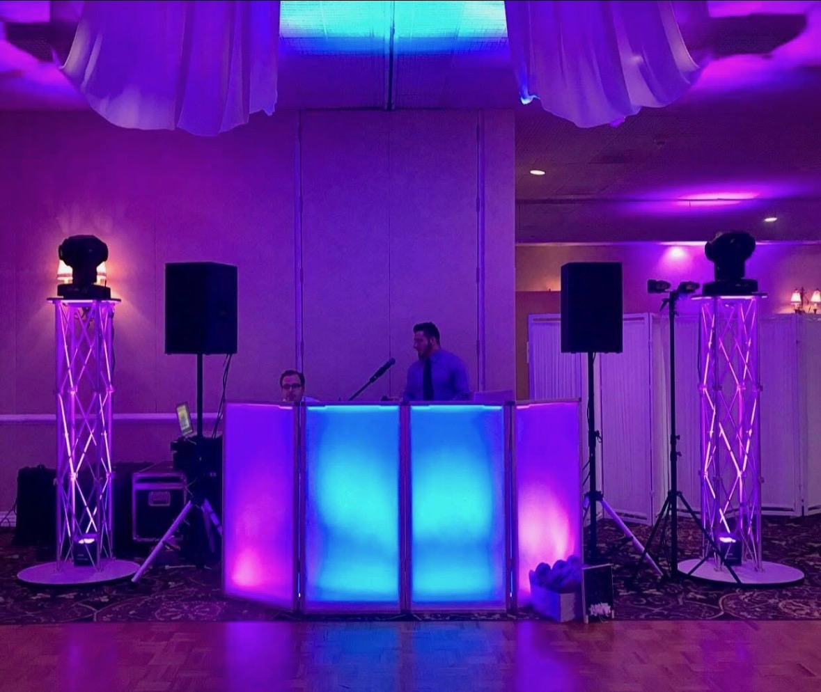 DJ booth with uplighting and production lighting